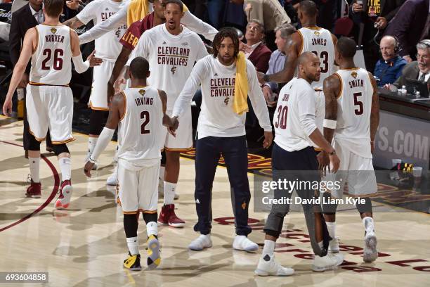 Derrick Williams of the Cleveland Cavaliers high fives teammates in Game Three of the 2017 NBA Finals against the Golden State Warriors on June 7,...