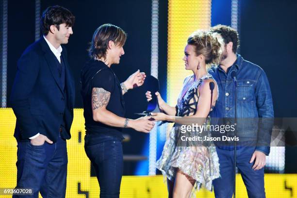 Carrie Underwood and Keith Urban accept the Collaborative Video award from Ashton Kutcher and Danny Masterson at the 2017 CMT Music Awards at the...