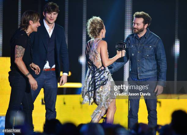 Carrie Underwood and Keith Urban accept the Collaborative Video award from Ashton Kutcher and Danny Masterson at the 2017 CMT Music Awards at the...