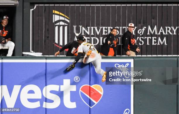 June 07: Pittsburgh Pirates center fielder Andrew McCutchen goes over the wall after an eighth inning solo home run by the Baltimore Orioles during...