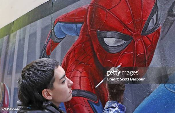 Apparition Media artist Tayla Broekman paints the final parts of the Spider-Man: Homecoming mural on June 8, 2017 in Melbourne, Australia. Apparition...