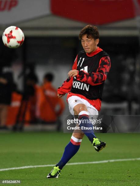 Tomoya Ugajin of Japan warms up during the international friendly match between Japan and Syria at Tokyo Stadium on June 7, 2017 in Chofu, Tokyo,...