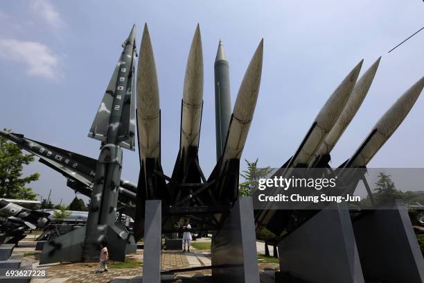 South Korean girl walks past replicas of a North Korean Scud-B missile and South Korean Hawk surface-to-air missiles at the Korean War Memorial in...