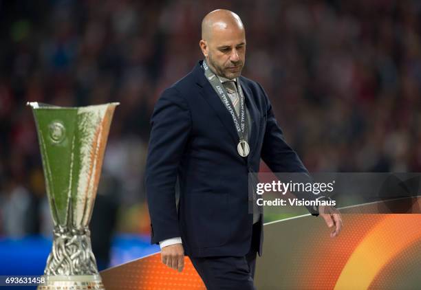 Ajax coach Peter Bosz walks past the trophy after the Europa League Final between Manchester United and AFC Ajax at the Friends Arena on May 24, 2017...