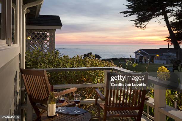 deck with wine and sunset - mendocino stock-fotos und bilder