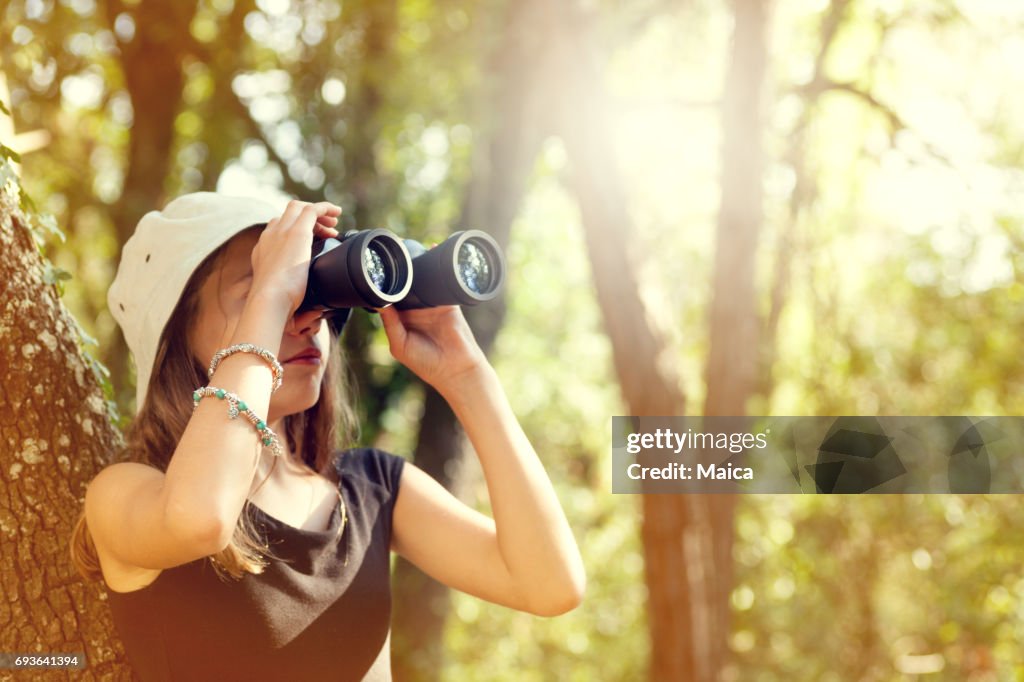 Young girl looking through binoculars