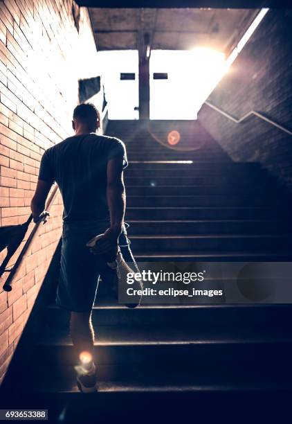 image of a fit man stretching his legs - alto contraste imagens e fotografias de stock