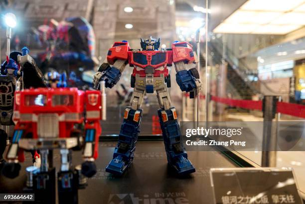 Optimus Prime's toys of various versions exhibited in a shopping mall, to propaganda for the new film "Transformers 5: the last knight"....
