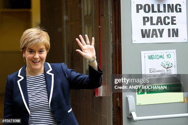 Scotland's First Minister and leader of the Scottish National Party , Nicola Sturgeon, gestures as she leaves a Polling Station after casting her...