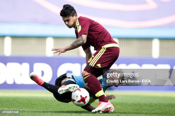 Nicolas de la Cruz of Uruguay is challanged by Samuel Sosa of Venezuela during the FIFA U-20 World Cup Korea Republic 2017 Semi Final match between...