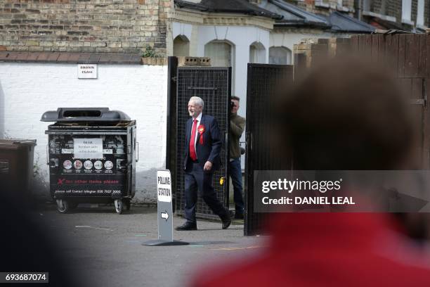 Britain's main opposition Labour Party leader Jeremy Corbyn arrives at a polling station to cast his vote in north London on June 8 as Britain holds...