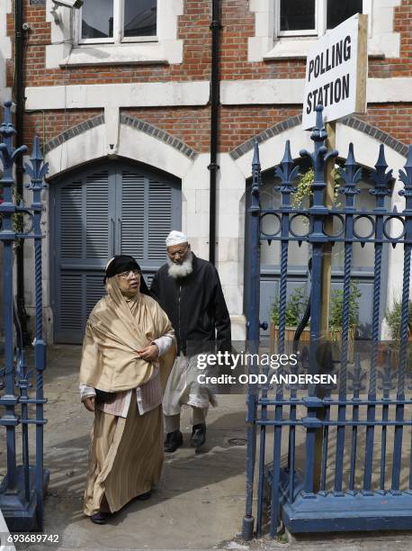 People are pictured outside a polling station on Brick Lane, east London on June 8 as Britain holds a general election. As polling stations across...