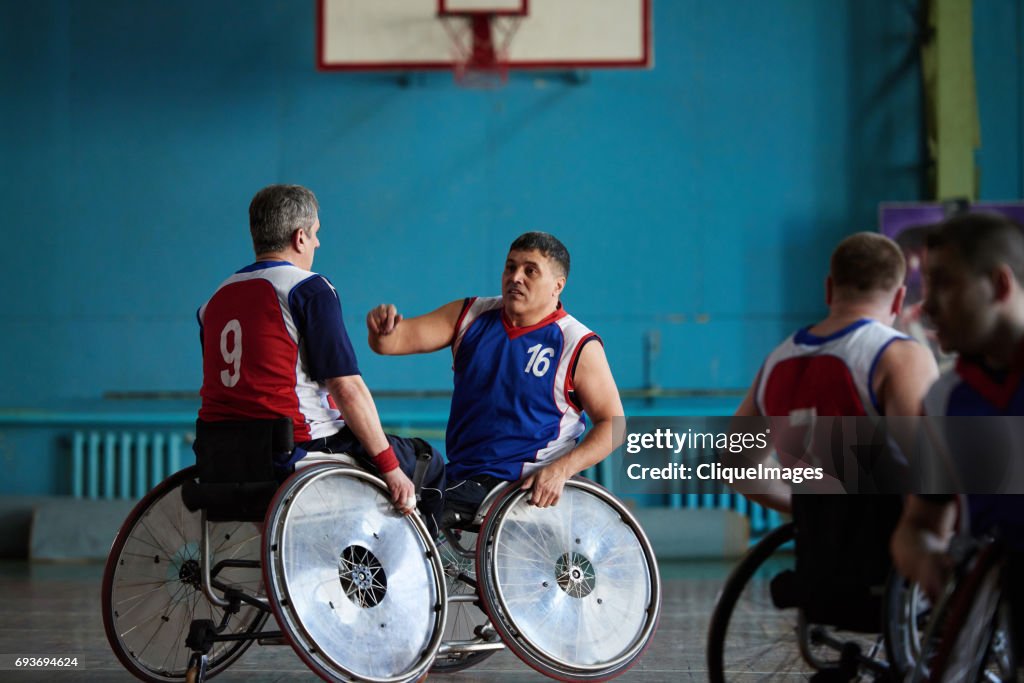 Handicapped basketball players discussing match