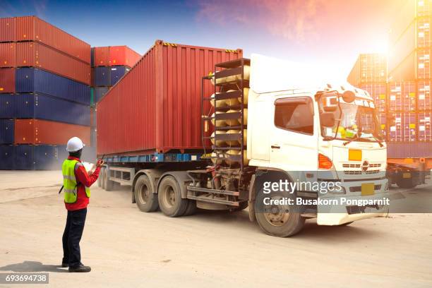 foreman control loading truck in container depot, containers box to truck for logistic import export background, business logistic concept - freight truck loading stock pictures, royalty-free photos & images