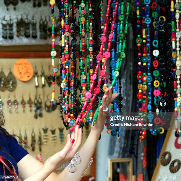 woman shopping for jewelry at "el rastro" flea market, madrid,, spain - el rastro stockfoto's en -beelden