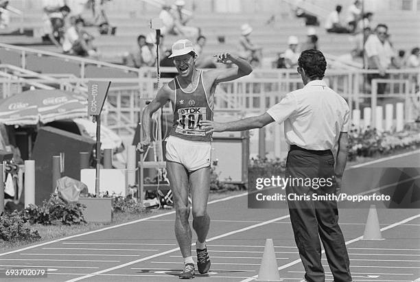 East German race walker Hartwig Gauder crosses the finish line in first place to win the gold medal in the Men's 50 kilometres walk event at the 1987...