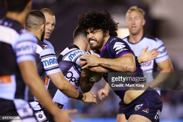 Tohu Harris of the Storm is tackled during the round 14 NRL match between the Cronulla Sharks and the Melbourne Storm at Southern Cross Group Stadium...