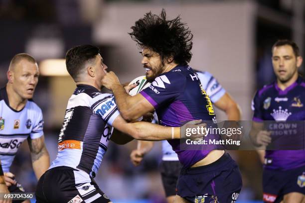 Tohu Harris of the Storm is tackled during the round 14 NRL match between the Cronulla Sharks and the Melbourne Storm at Southern Cross Group Stadium...