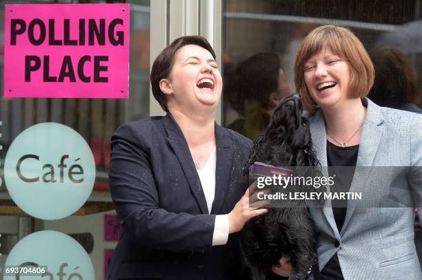 Scottish Conservative leader, Ruth Davidson , poses with her partner Jen Wilson and their dog Mister Wilson, at a cafe set up as a Polling Station,...