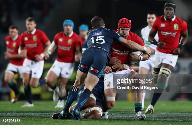 James Haskell of the Lions is tackled by Michael Collins during the match between the Auckland Blues and the British & Irish Lions at Eden Park on...