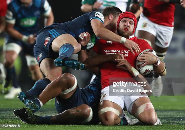 James Haskell of the Lions is tackled by Michael Collins during the match between the Auckland Blues and the British & Irish Lions at Eden Park on...