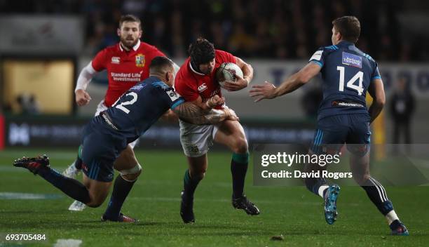 Leigh Halfpenny of the Lions is tackled by Sonny-Bill Williams during the match between the Auckland Blues and the British & Irish Lions at Eden Park...