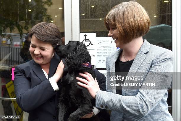 Scottish Conservative leader, Ruth Davidson , poses with her partner Jen Wilson and their dog Mister Wilson, at a cafe set up as a Polling Station,...