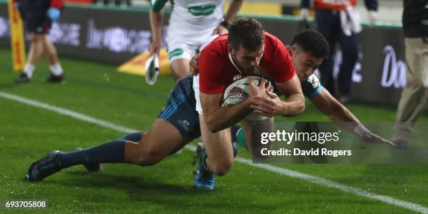 Jerad Payne of the Lions is tackled just short of the try line during the match between the Auckland Blues and the British & Irish Lions at Eden Park...