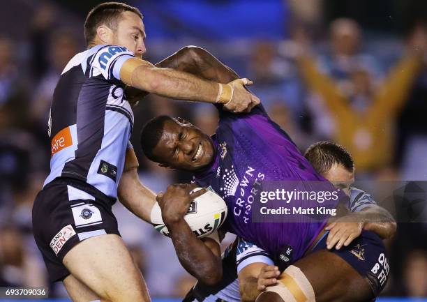 Suliasi Vunivalu of the Storm is tackled during the round 14 NRL match between the Cronulla Sharks and the Melbourne Storm at Southern Cross Group...