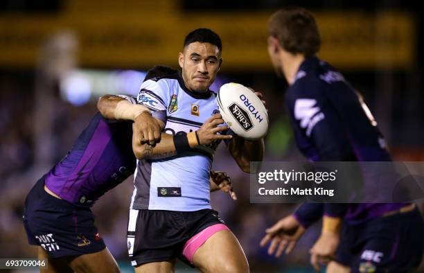 Valentine Holmes of the Sharks is tackled during the round 14 NRL match between the Cronulla Sharks and the Melbourne Storm at Southern Cross Group...