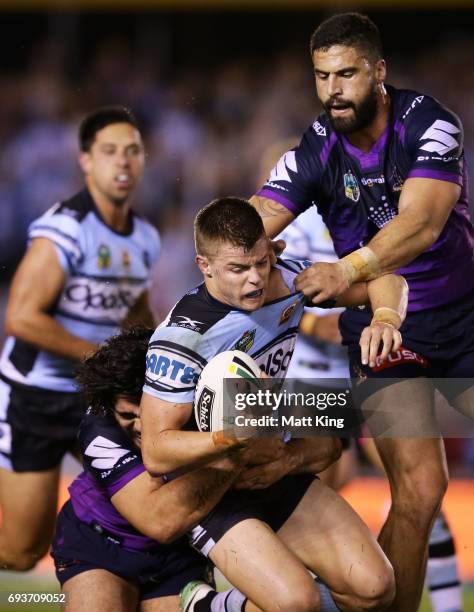 Jayden Brailey of the Sharks is tackled during the round 14 NRL match between the Cronulla Sharks and the Melbourne Storm at Southern Cross Group...