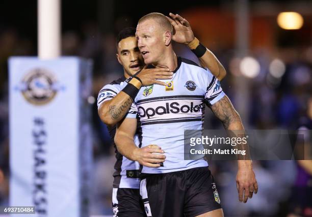 Luke Lewis of the Sharks celebrates with Valentine Holmes of the Sharks after scoring a try during the round 14 NRL match between the Cronulla Sharks...