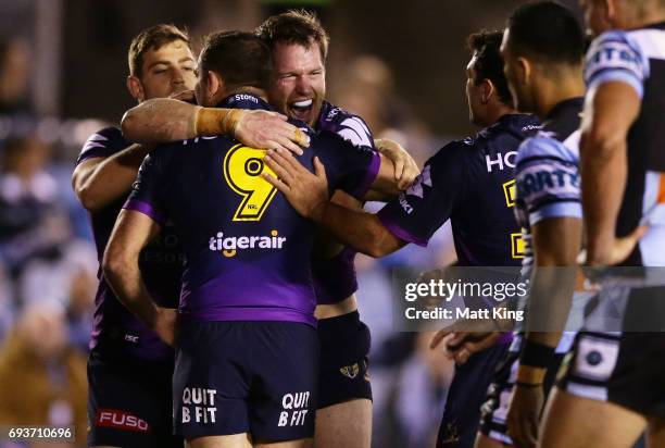 Tim Glasby of the Storm celebrates with team mates after scoring a try during the round 14 NRL match between the Cronulla Sharks and the Melbourne...