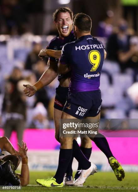 Tim Glasby of the Storm celebrates with team mates after scoring a try during the round 14 NRL match between the Cronulla Sharks and the Melbourne...