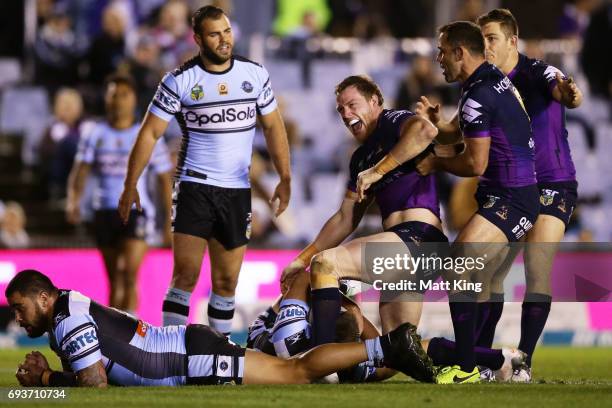 Tim Glasby of the Storm celebrates with team mates after scoring a try during the round 14 NRL match between the Cronulla Sharks and the Melbourne...