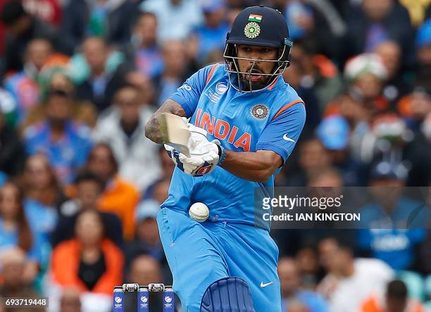 India's Shikhar Dhawan miss-times his swing and his hit by a ball during the ICC Champions Trophy match between India and Sri Lanka at The Oval in...