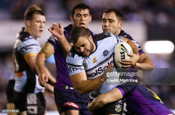 Wade Graham of the Sharks is tackled during the round 14 NRL match between the Cronulla Sharks and the Melbourne Storm at Southern Cross Group...