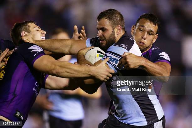 Wade Graham of the Sharks is tackled during the round 14 NRL match between the Cronulla Sharks and the Melbourne Storm at Southern Cross Group...