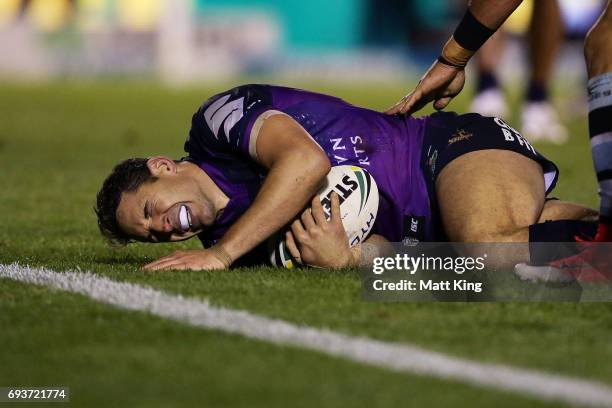 Billy Slater of the Storm shows discomfort and appears to be injured in a tackle during the round 14 NRL match between the Cronulla Sharks and the...