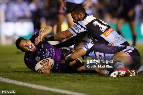Billy Slater of the Storm shows discomfort and appears to be injured in a tackle during the round 14 NRL match between the Cronulla Sharks and the...