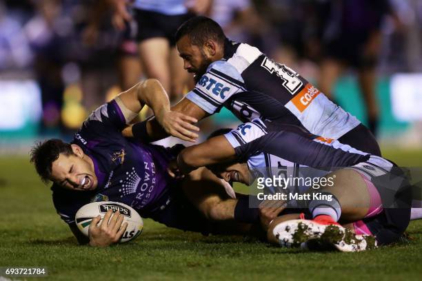 Billy Slater of the Storm shows discomfort and appears to be injured in a tackle during the round 14 NRL match between the Cronulla Sharks and the...