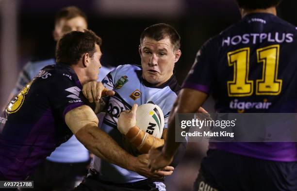 Paul Gallen of the Sharks takes on the defence during the round 14 NRL match between the Cronulla Sharks and the Melbourne Storm at Southern Cross...