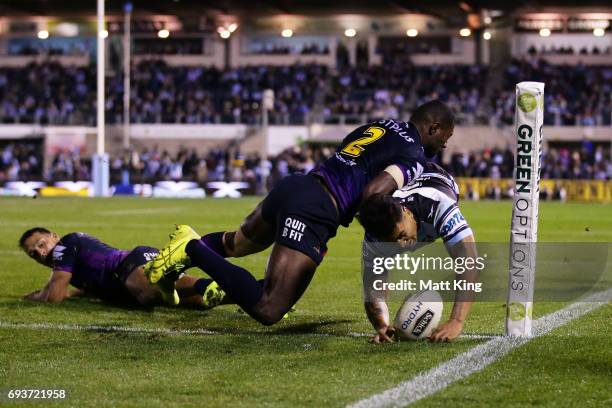 Sosaia Feki of the Sharks beats Suliasi Vunivalu of the Storm to score in the corner during the round 14 NRL match between the Cronulla Sharks and...