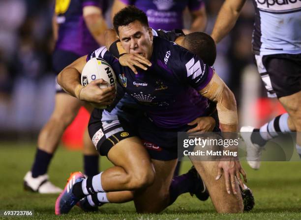 Nelson Asofa-Solomona of the Storm is tackled during the round 14 NRL match between the Cronulla Sharks and the Melbourne Storm at Southern Cross...