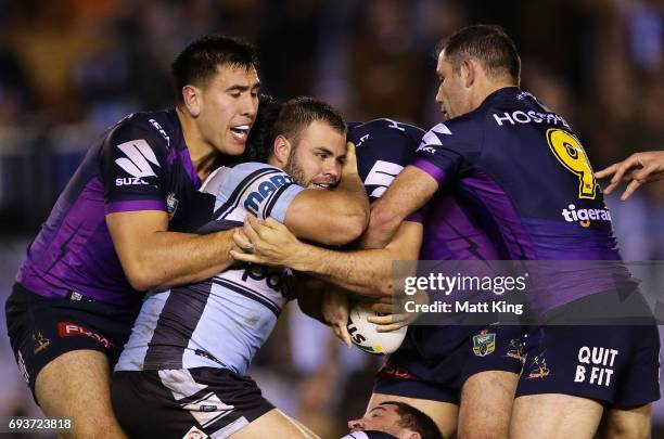 Wade Graham of the Sharks is tackled during the round 14 NRL match between the Cronulla Sharks and the Melbourne Storm at Southern Cross Group...