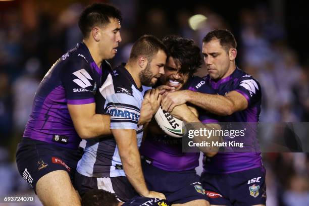 Wade Graham of the Sharks is tackled during the round 14 NRL match between the Cronulla Sharks and the Melbourne Storm at Southern Cross Group...