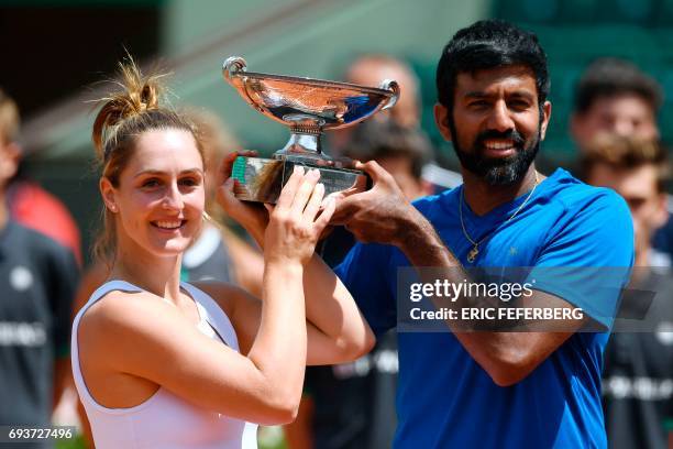 India's Rohan Bopanna and Canada's Gabriela Dabrowski pose with their trophy after winning their mixed doubles tennis match against Colombia's Robert...