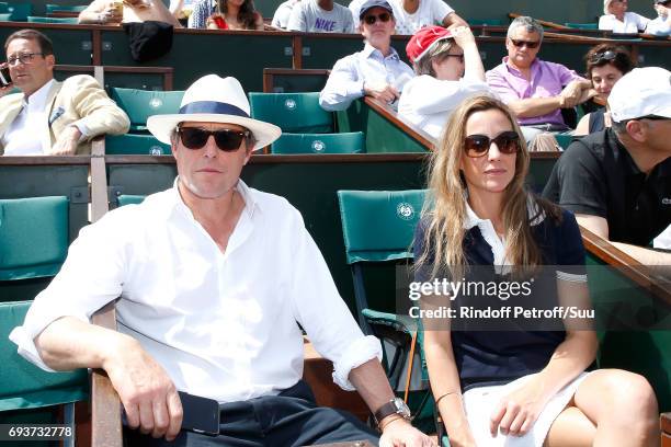 Actor Hugh Grant and Anna Eberstein attend the 2017 French Tennis Open - Day Twelve at Roland Garros on June 8, 2017 in Paris, France.