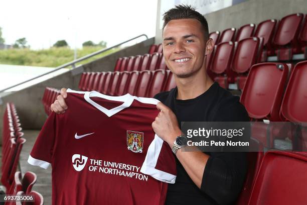 Northampton Town New Signing Billy Waters poses with a shirt during a photo call at Sixfields on June 8, 2017 in Northampton, England.