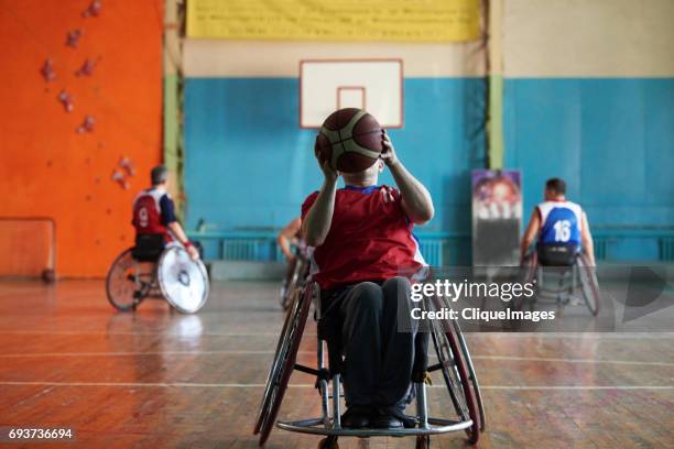 Wheelchair athlete shooting basketball